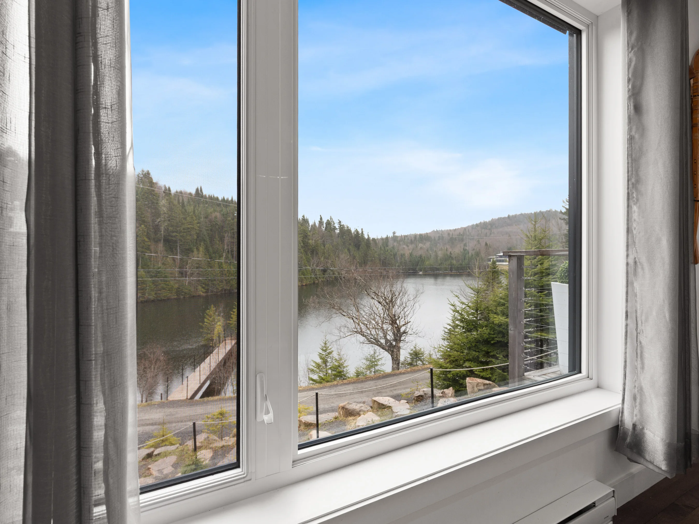 Lake and mountain view from a window at Le Céleste chalet