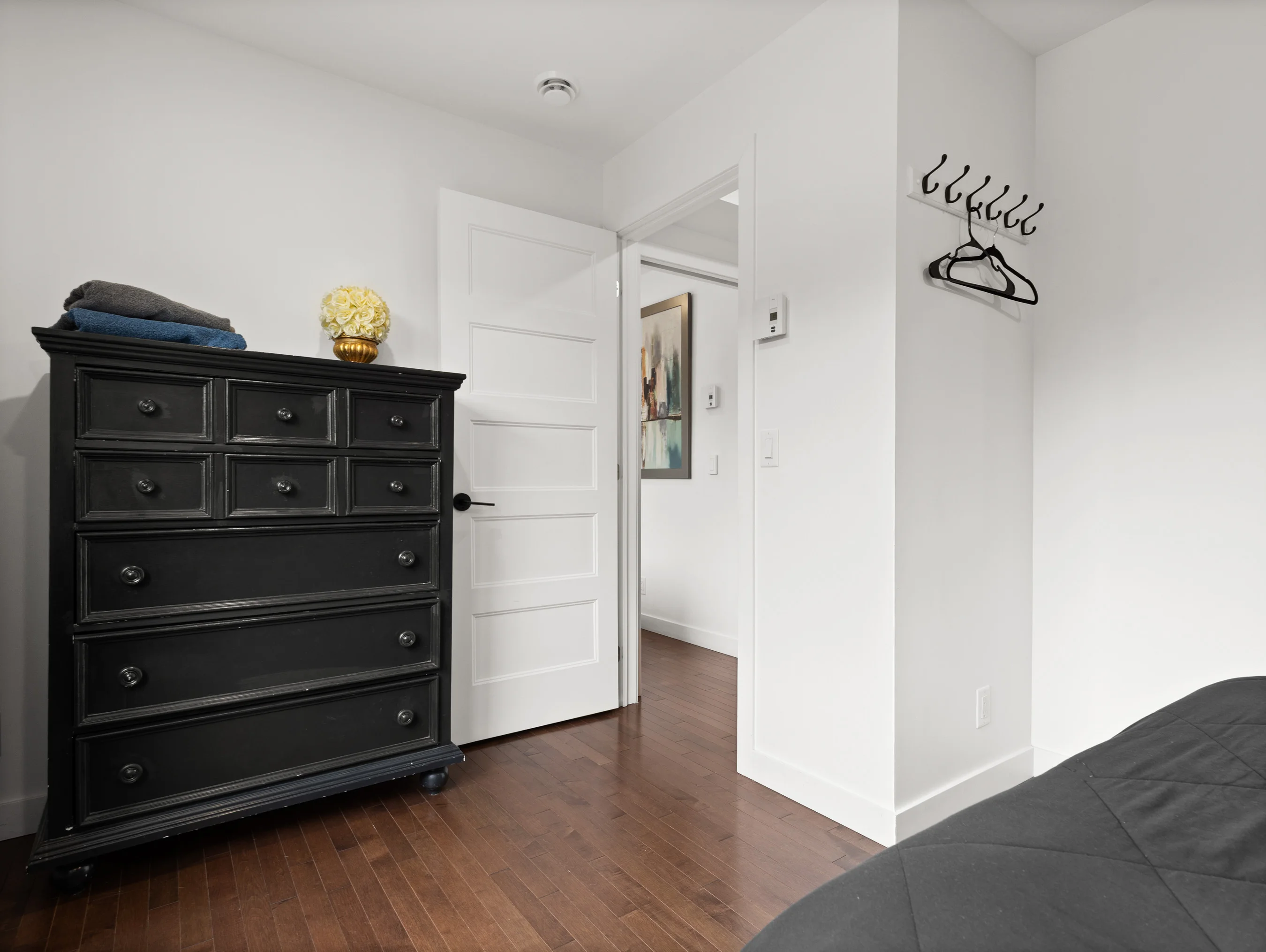Bedroom storage area with dresser and hooks at Le Céleste chalet